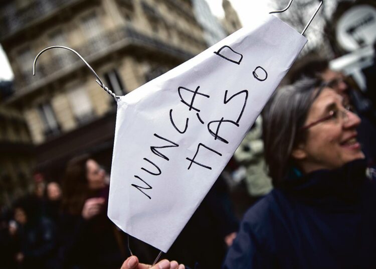 Perinteiseen laittomien aborttien tekovälineeseen oli liitetty lappu ”Ei koskaan enää” Espanjan aborttilain tiukennusta vastustaneessa mielenosoituksessa Pariisissa joulukuussa.