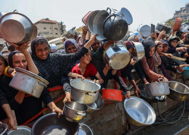Nälän riuduttamat Gazan asukkaat jonottavat ruokaa avustuspisteellä.