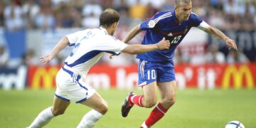 Kreikan Traianos Dellas (vas.) pelasi liberona Ranska-ottelussa vuoden 2004 EM-kisoissa. Oikealla Dellasia yrittää ohittaa Zinedine Zidane.