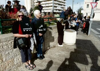 Polly Amrein (oikealla) Women in Black -järjestön mielenosoituksessa Länsi-Jerusalemissa. Kylteissä lukee arabiaksi ja hepreaksi ”Lopettakaa miehitys”.