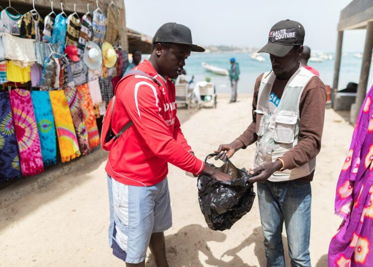Katukauppias pakkasi asiakkaan ostokset kertakäyttöiseen muovipussiin Senegalin pääkaupungissa Dakarissa helmikuussa.