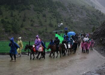 Pyhiinvaeltajia hevosmiesten ja kantajien saattamina matkaansa Baltalin reitillä vuotuisen Amarnath Yatra -pyhiinvaelluksen aikana Jammussa ja Kashmirissa heinäkuussa 2026.