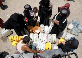 Naiset noutivat vettä leirille toimitetulta vesipisteeltä Sanaassa syyskuussa.