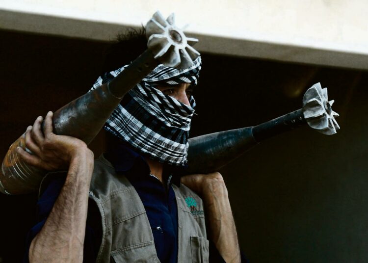 Kapinallistaistelija kantamassa kranaatinheittimen ammuksia Raqqassa Pohjois-Syyriassa.