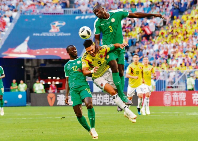 ”Terangan leijonat” pelasi MM-kisoissa erinomaisen organisoitua, mutta silti viihdyttävää peliä. Kolumbian Falcao joutui Senegalin Youssouf Sabalyn (vas.) ja Kalidou Koulibalyn puristukseen.